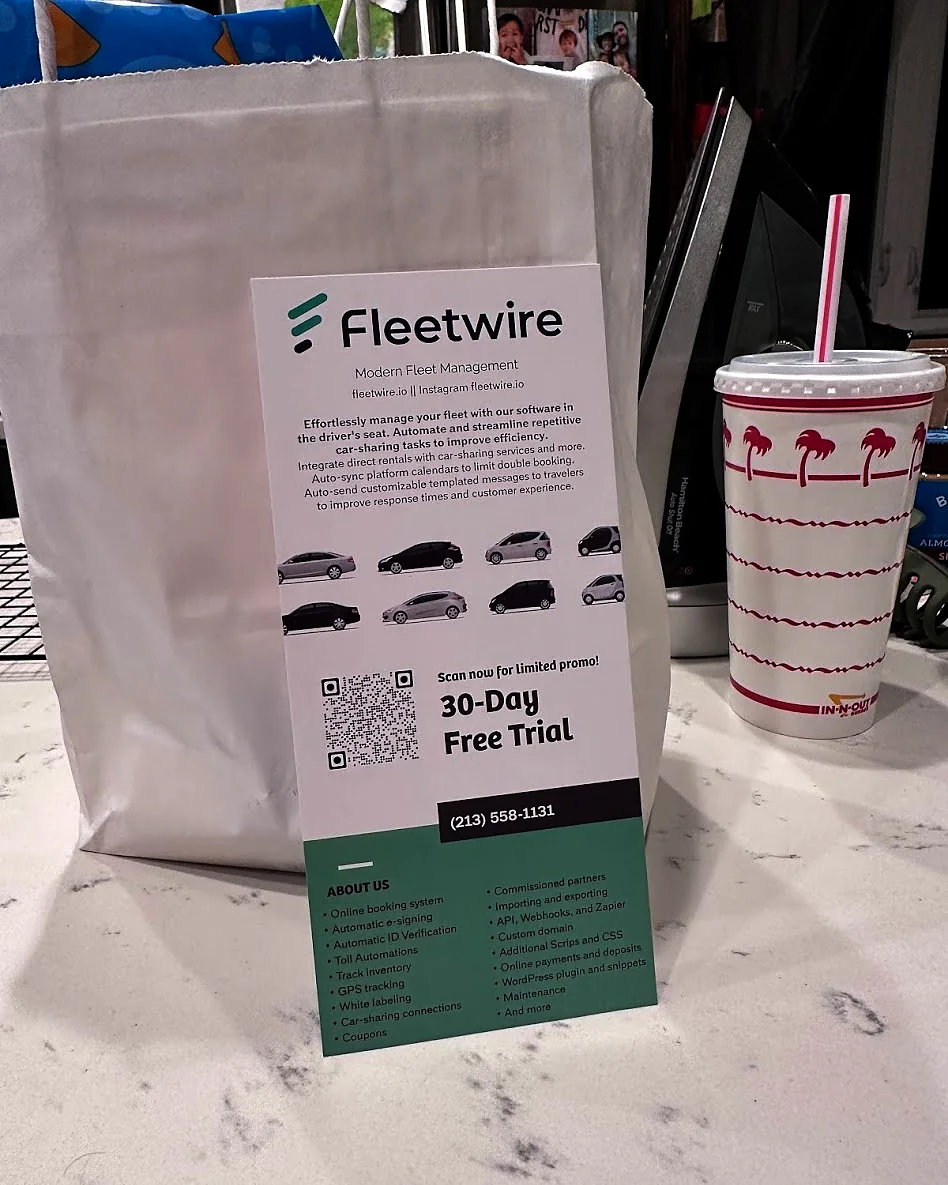 Fleetwire rack card offering a 30-day free trial, next to an In-N-Out cup